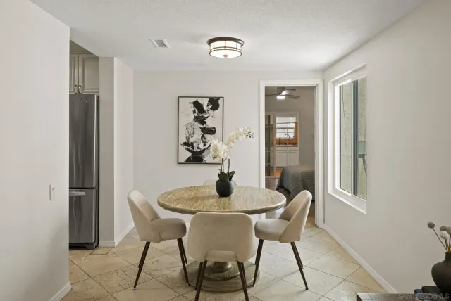 a dining room with furniture and window