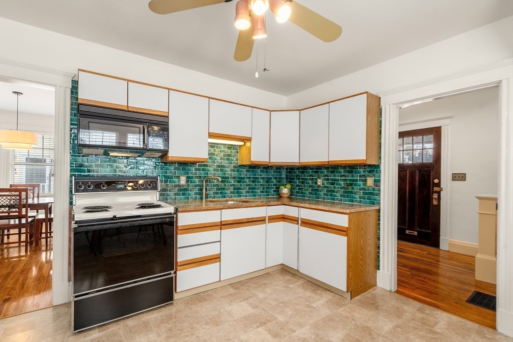16 Isabella Street Lynn, MA 01902 - Photo 14 of 26 a kitchen with stainless steel appliances granite countertop a stove and a refrigerator