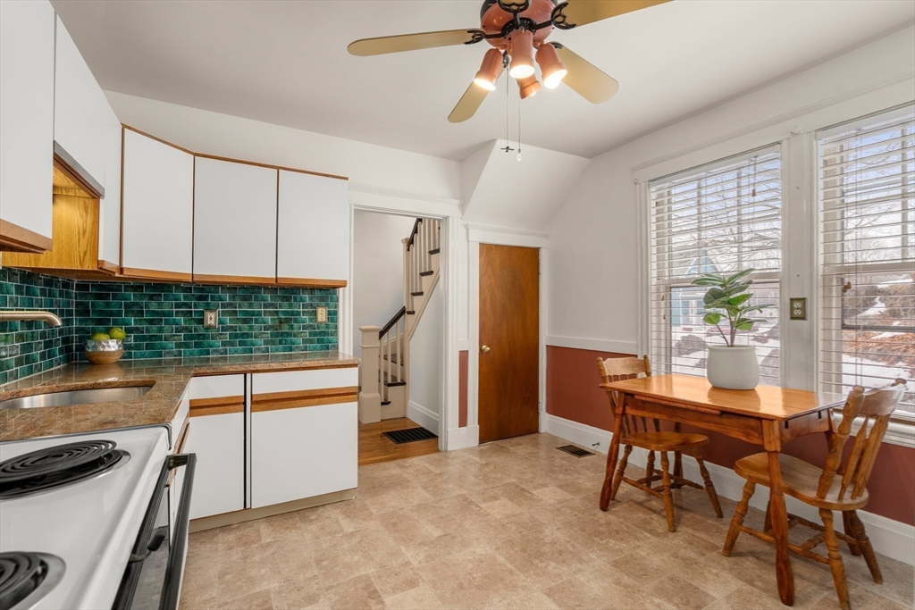 16 Isabella Street Lynn, MA 01902 - Photo 15 of 26 a kitchen with stainless steel appliances kitchen island a table and chairs in it
