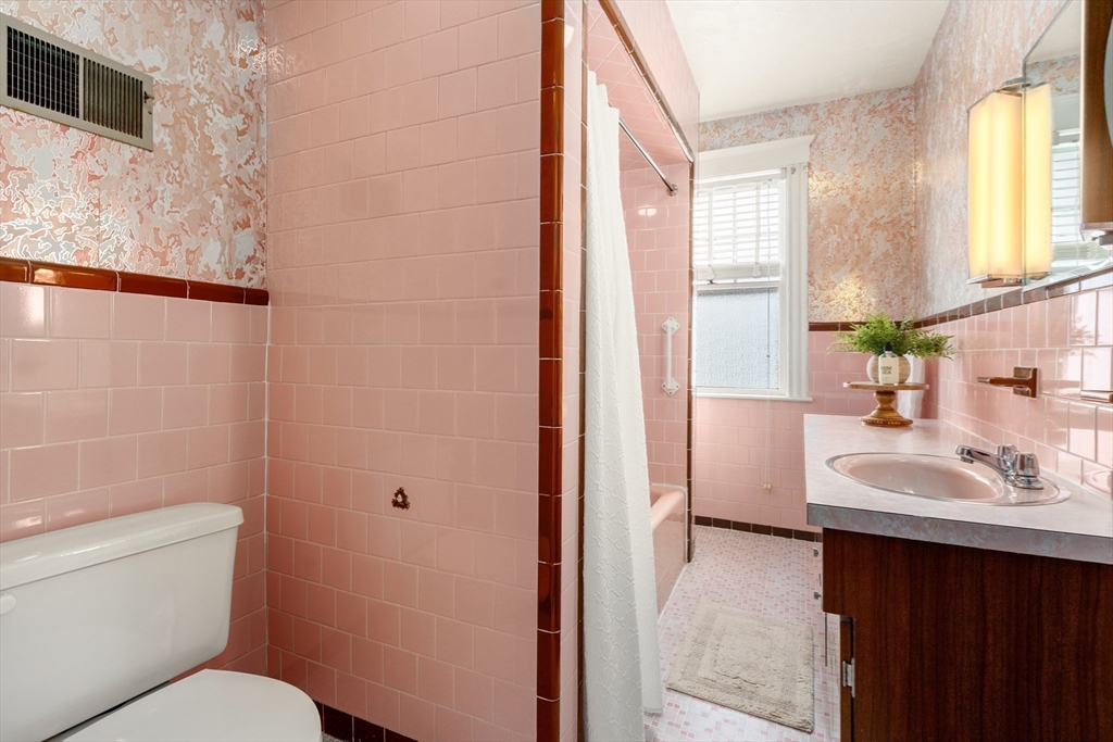 16 Isabella Street Lynn, MA 01902 - Photo 18 of 26 a bathroom with a sink toilet vanity and window
