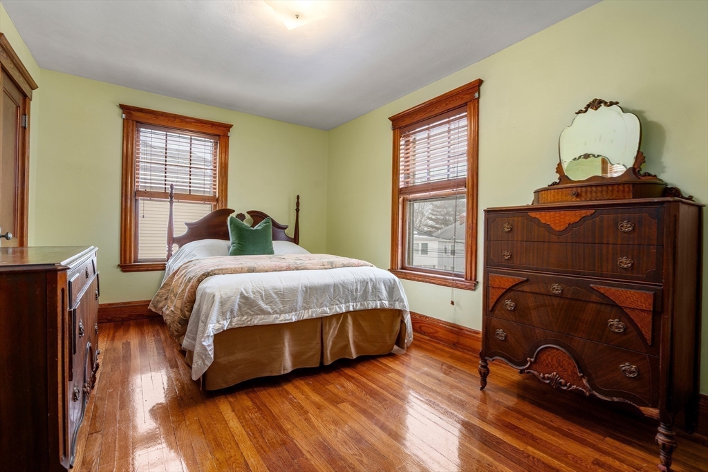 16 Isabella Street Lynn, MA 01902 - Photo 19 of 26 a bedroom with a bed and wooden floor