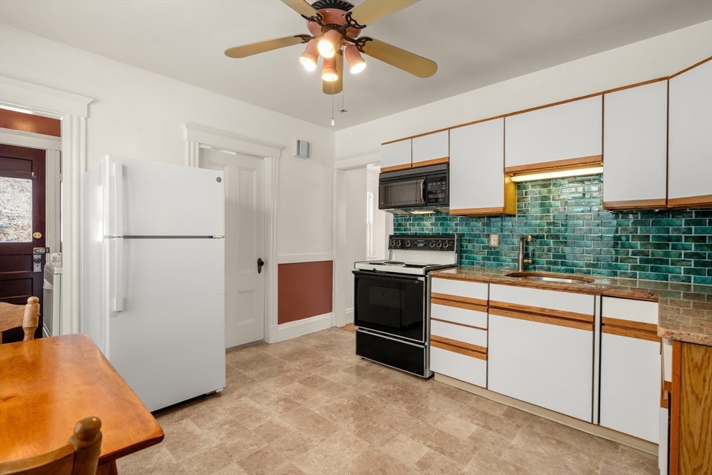 16 Isabella Street Lynn, MA 01902 - Photo 9 of 26 a kitchen with stainless steel appliances granite countertop a refrigerator and a sink