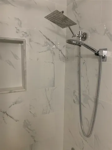 a bathroom with a bathtub and shower