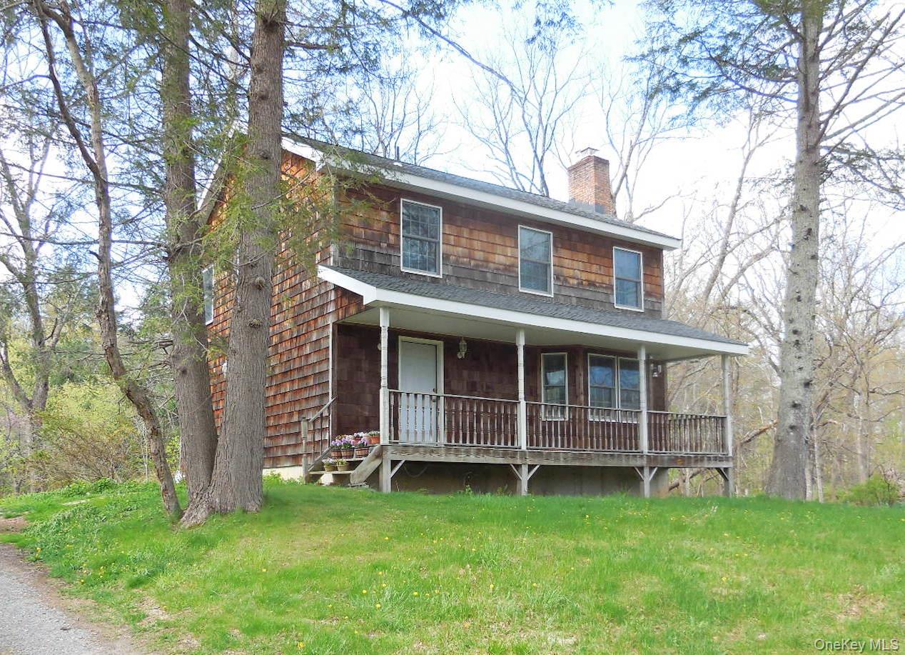 617 Burlingham Road Bloomingburg, NY 12721 - Photo 1 of 39 Wood-sided residence featuring a covered front porch, front yard & driveway to the left.