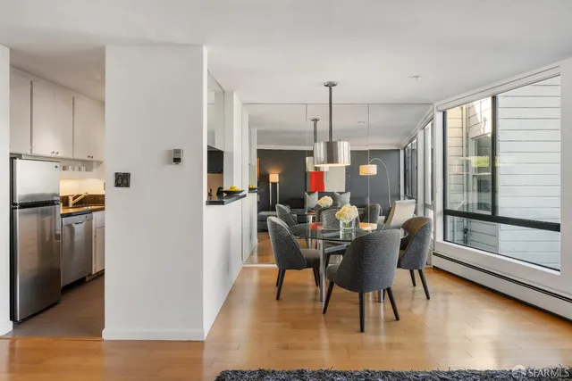 a view of a dining room with furniture and a window