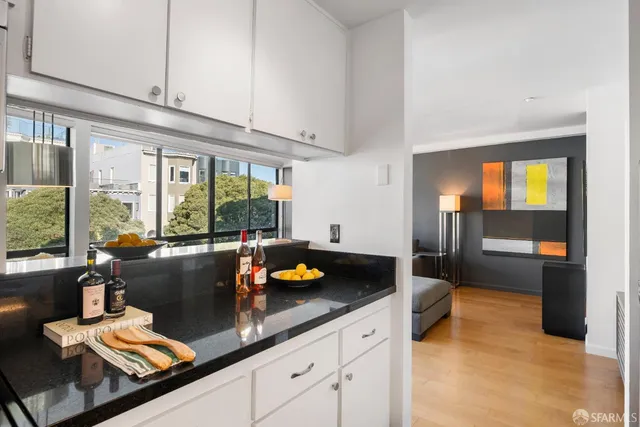 a kitchen with a sink and large windows