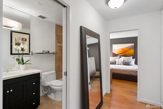 a bathroom with a toilet a sink and mirror