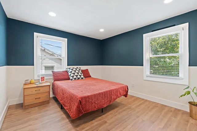 a bedroom with a bed and a window