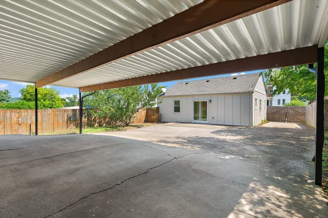 a backyard of a house with a garden and outdoor seating