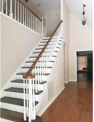a view of entryway and hall with wooden floor