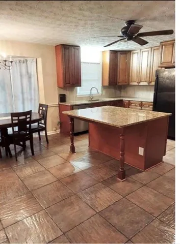 a large kitchen with lots of counter space and a sink