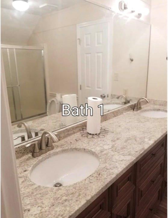 771 Lord Road Commerce, GA 30530 - Photo 7 of 16 a bathroom with a granite countertop sink and a mirror