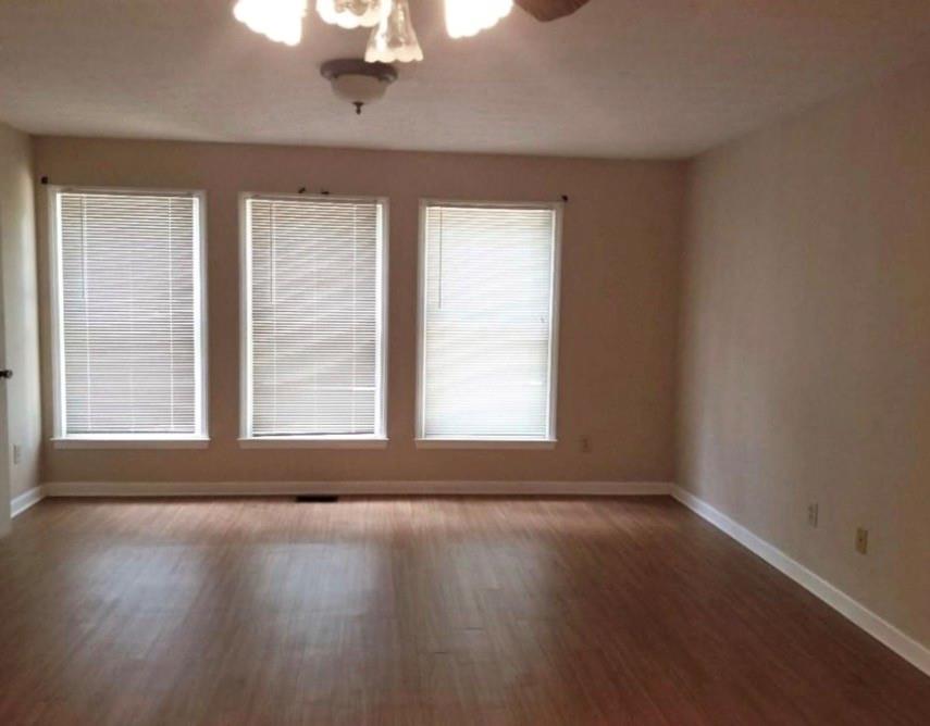 771 Lord Road Commerce, GA 30530 - Photo 8 of 16 a view of an empty room with wooden floor and a window