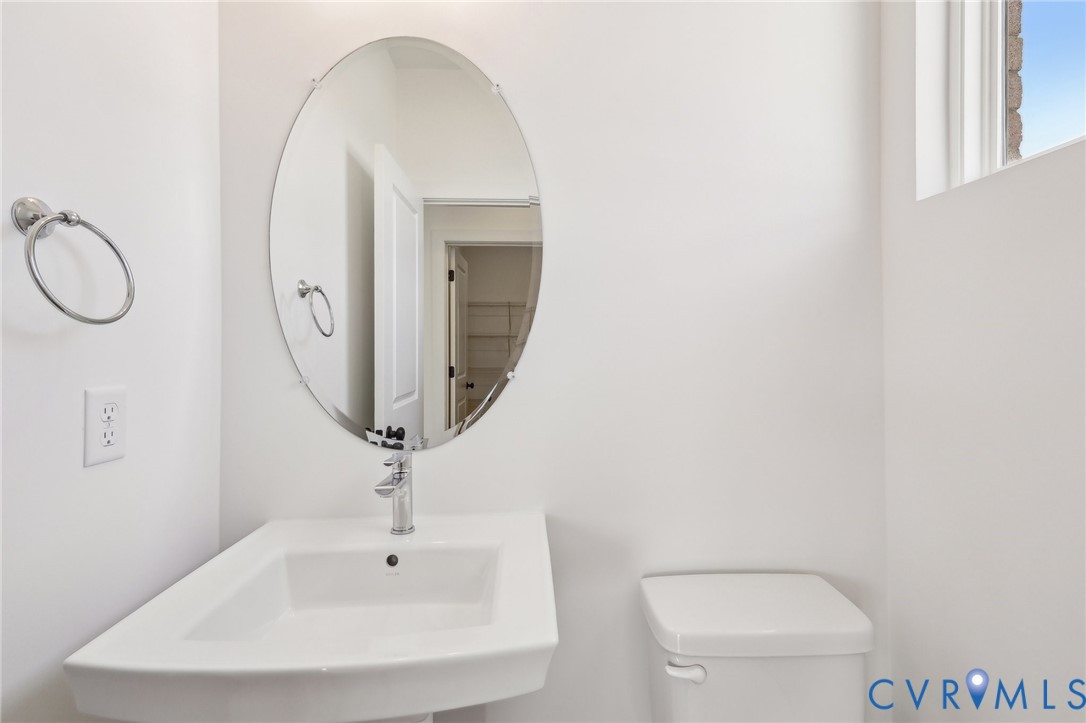 12002 Afternoon Path Henrico, VA 23233 - Photo 13 of 34 a bathroom with a toilet sink and mirror