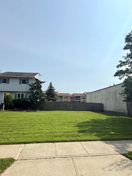 77 Hampton Place Freeport, NY 11520 - Photo 2 of 21 a view of a field with a yard