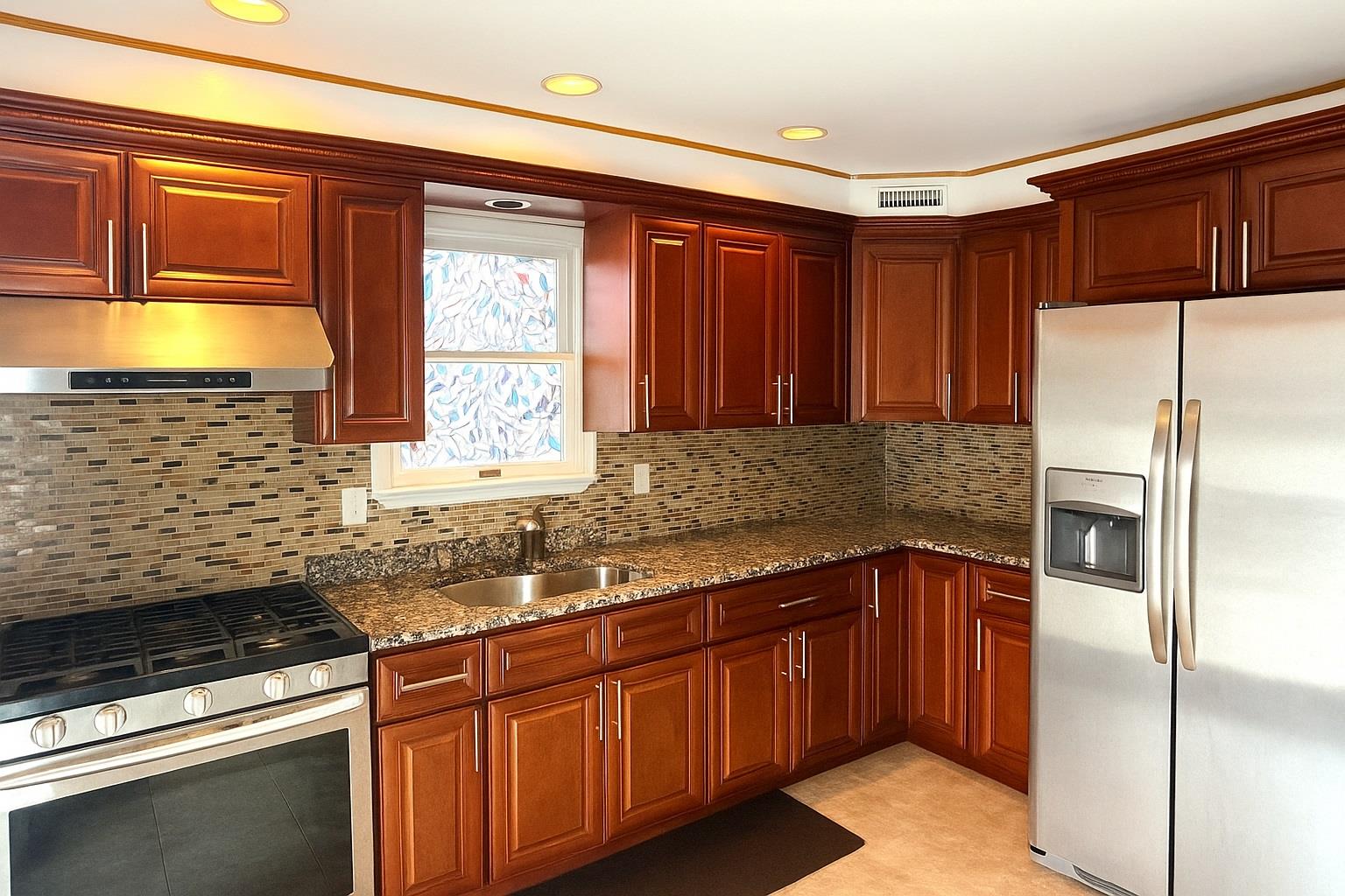 77 Hampton Place Freeport, NY 11520 - Photo 7 of 21 a kitchen with stainless steel appliances granite countertop a sink stove and refrigerator