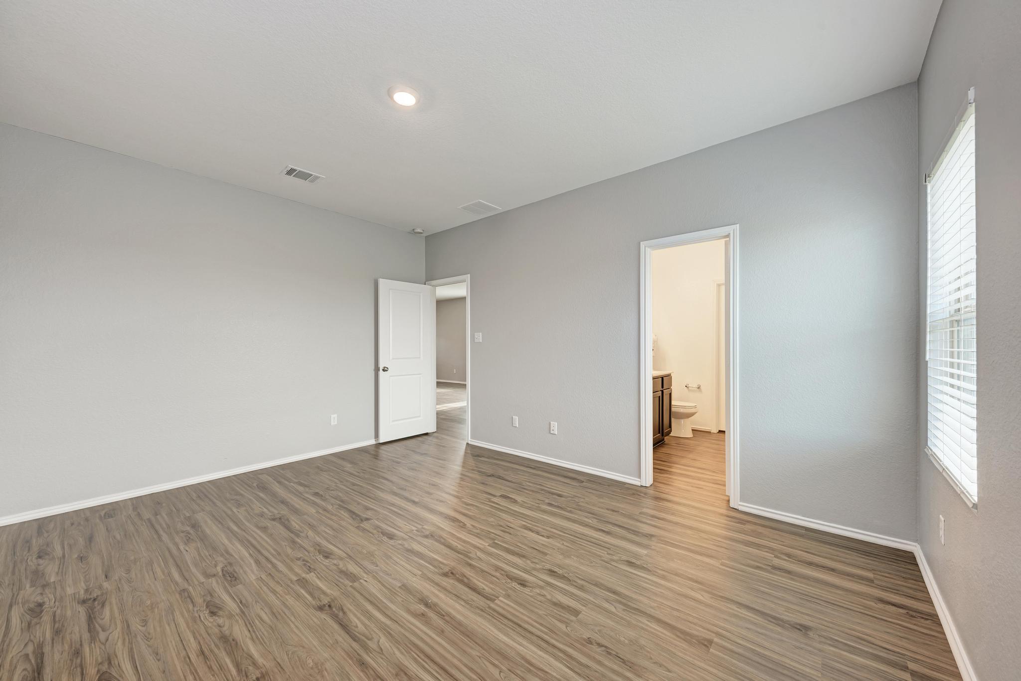 129 Vulcan Drive Jarrell, TX 76537 - Photo 19 of 35 a view of an empty room with wooden floor and a window