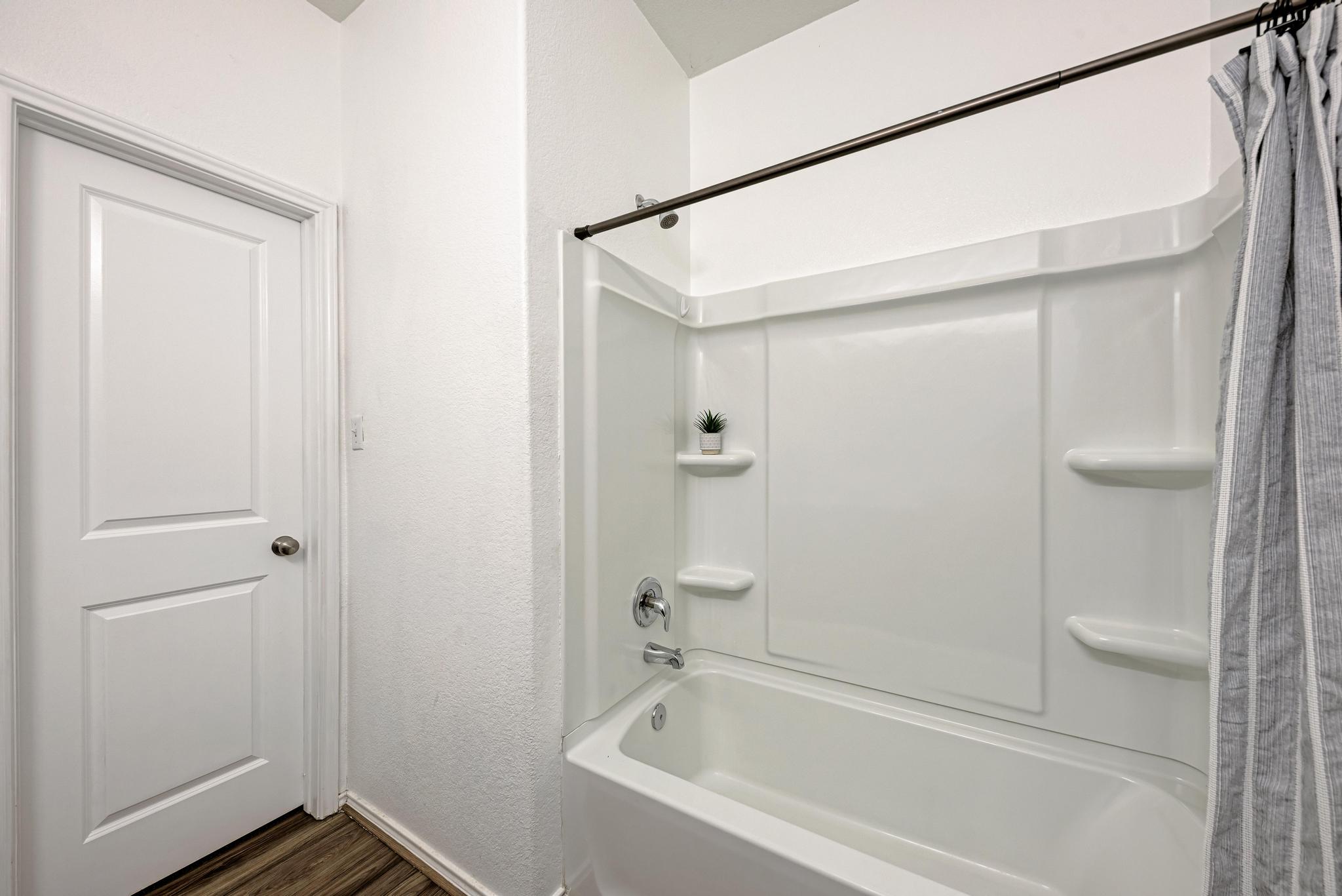 129 Vulcan Drive Jarrell, TX 76537 - Photo 21 of 35 a bathroom with a bathtub and a shower