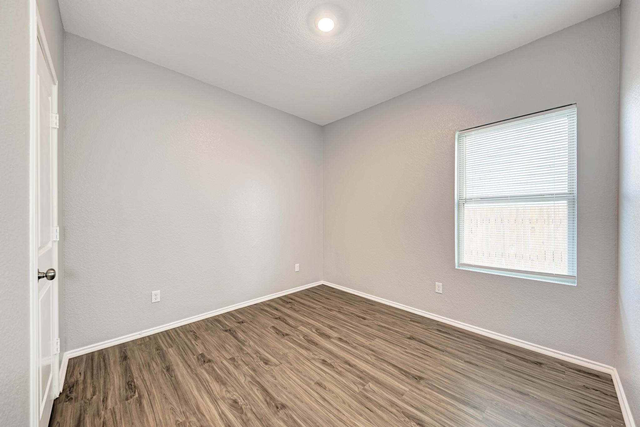 129 Vulcan Drive Jarrell, TX 76537 - Photo 26 of 35 an empty room with wooden floor and windows