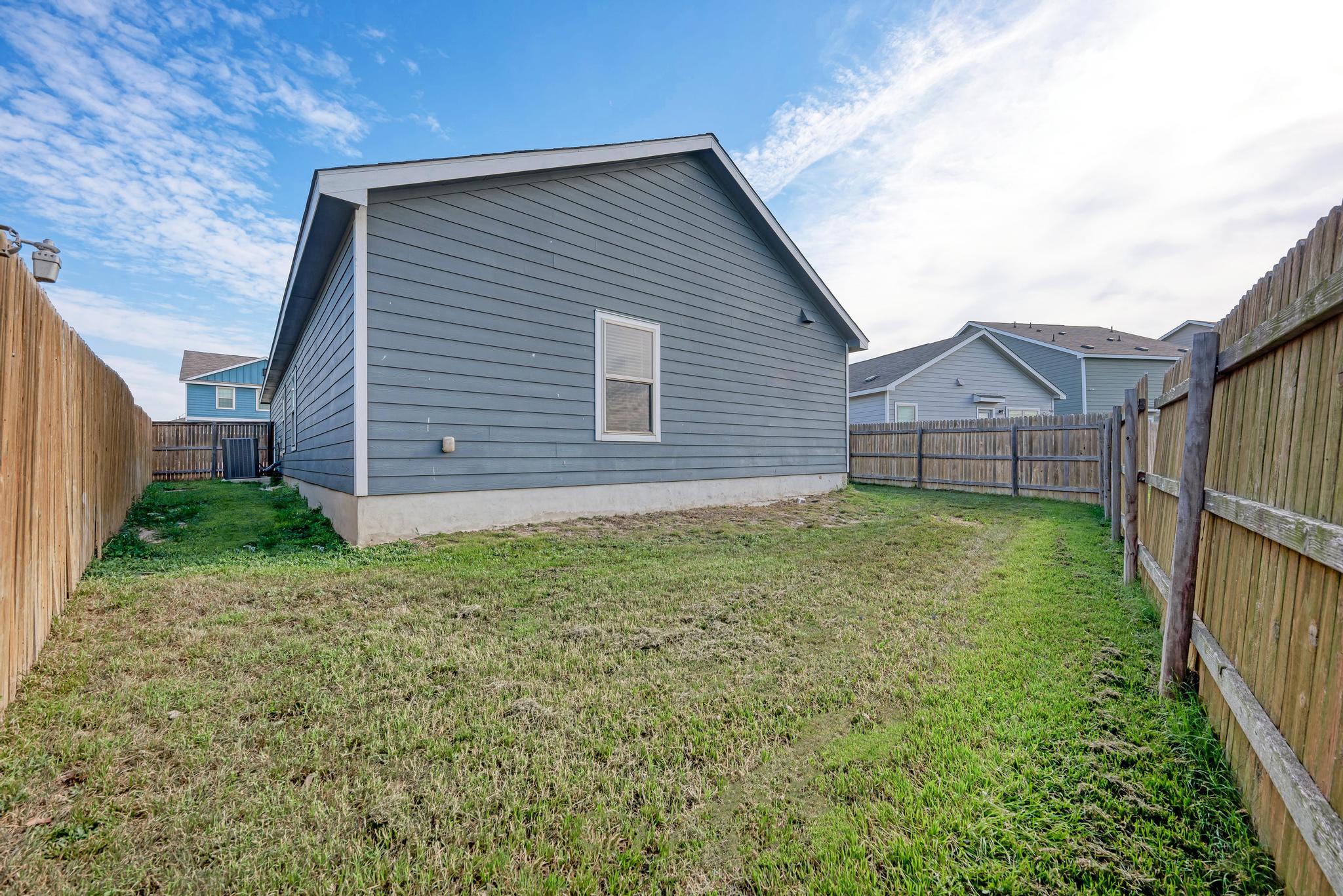 129 Vulcan Drive Jarrell, TX 76537 - Photo 30 of 35 a view of a house with a yard and wooden fence