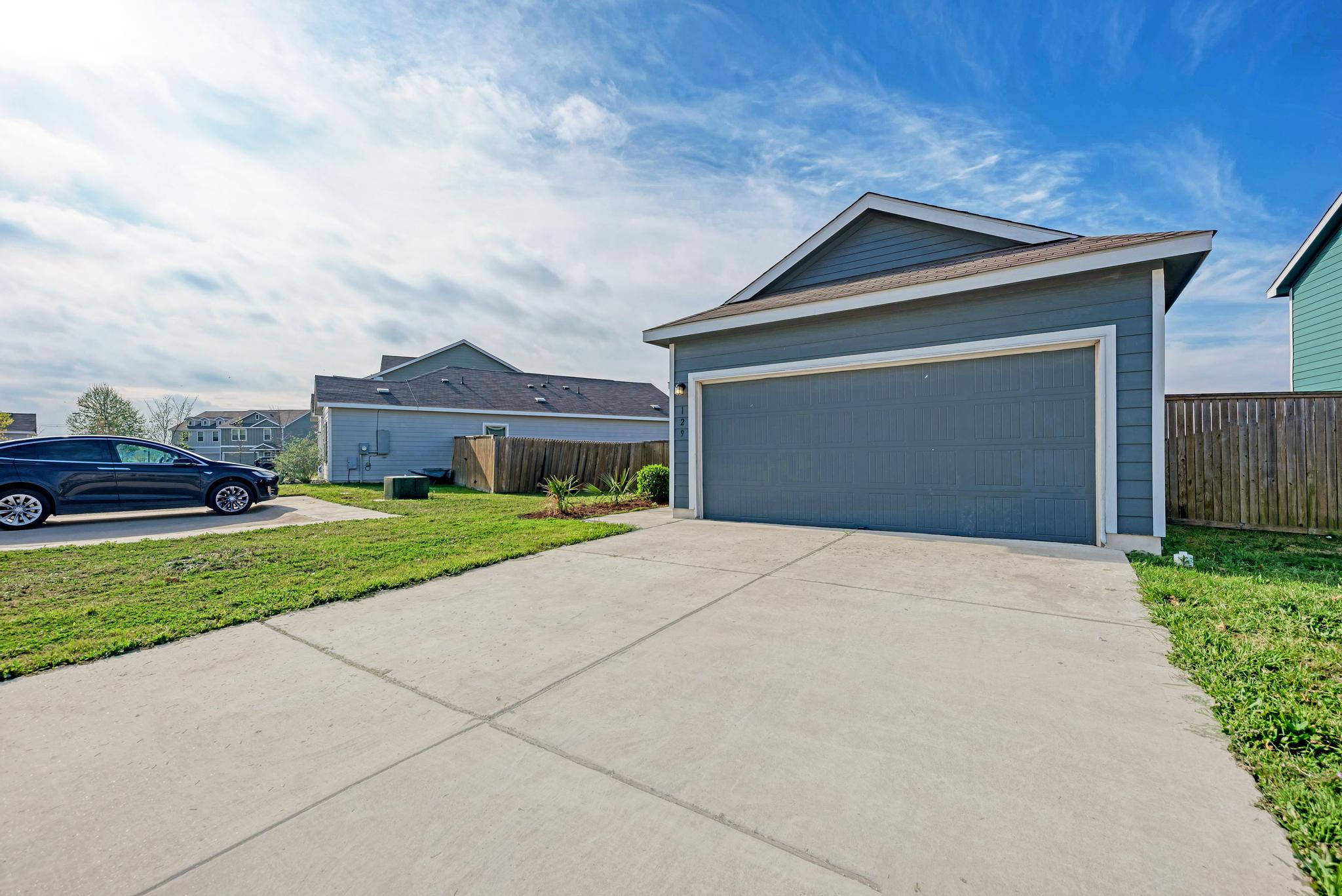 129 Vulcan Drive Jarrell, TX 76537 - Photo 4 of 35 a front view of a house with a yard and garage