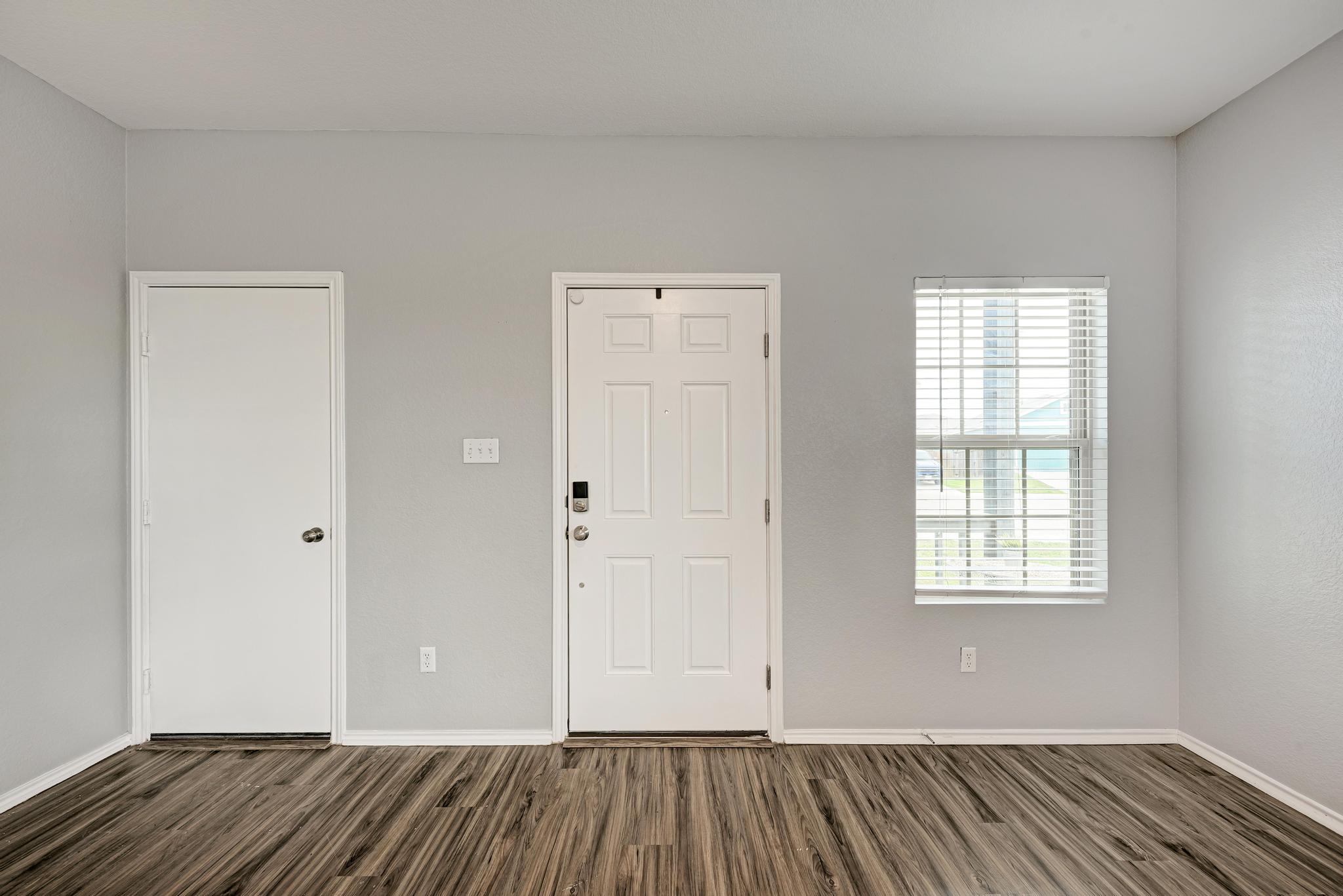 129 Vulcan Drive Jarrell, TX 76537 - Photo 6 of 35 a view of an empty room with wooden floor and a window