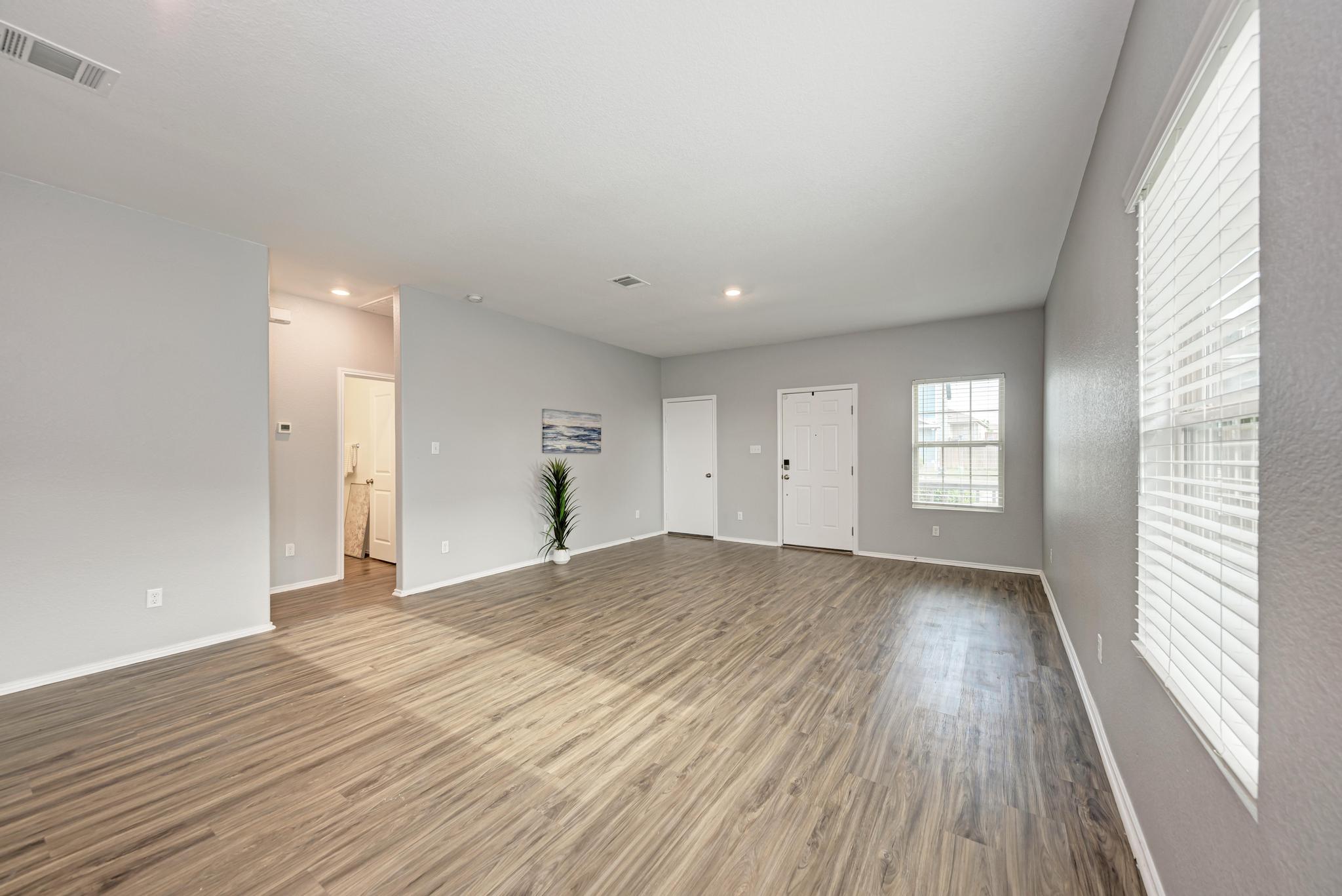 129 Vulcan Drive Jarrell, TX 76537 - Photo 9 of 35 a view of empty room with wooden floor and fan