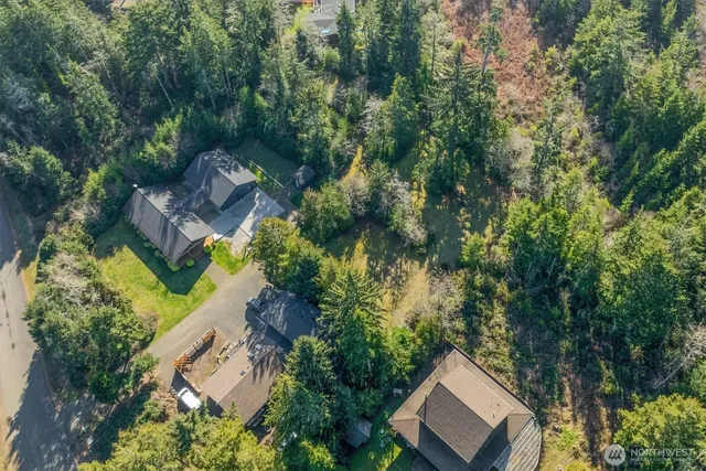 an aerial view of a house with yard