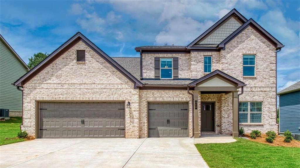 a front view of a house with a yard and garage