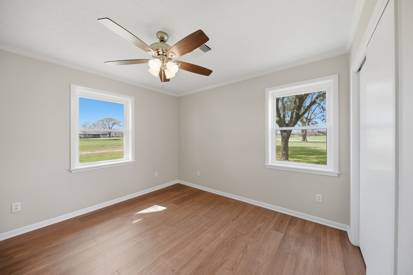 3249 Newsom Road Bellville, TX 77418 - Photo 11 of 20 a view of an empty room with wooden floor and a window