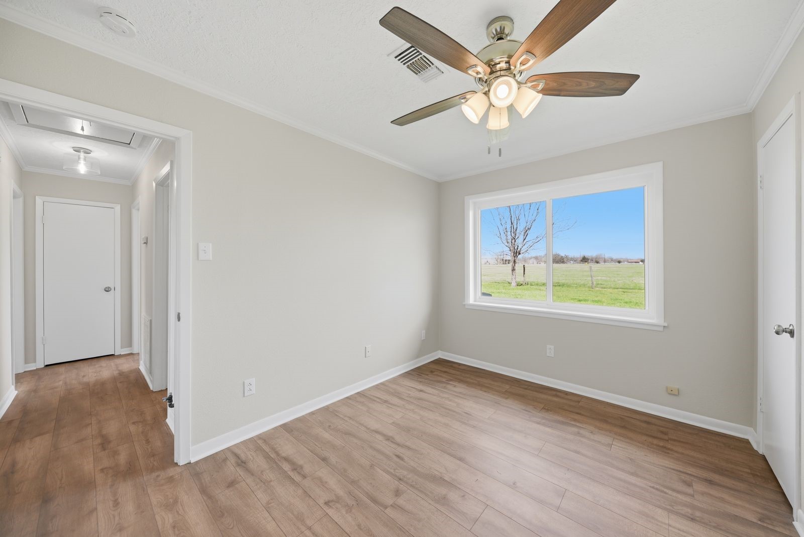 3249 Newsom Road Bellville, TX 77418 - Photo 12 of 20 wooden floor in an empty room with a window