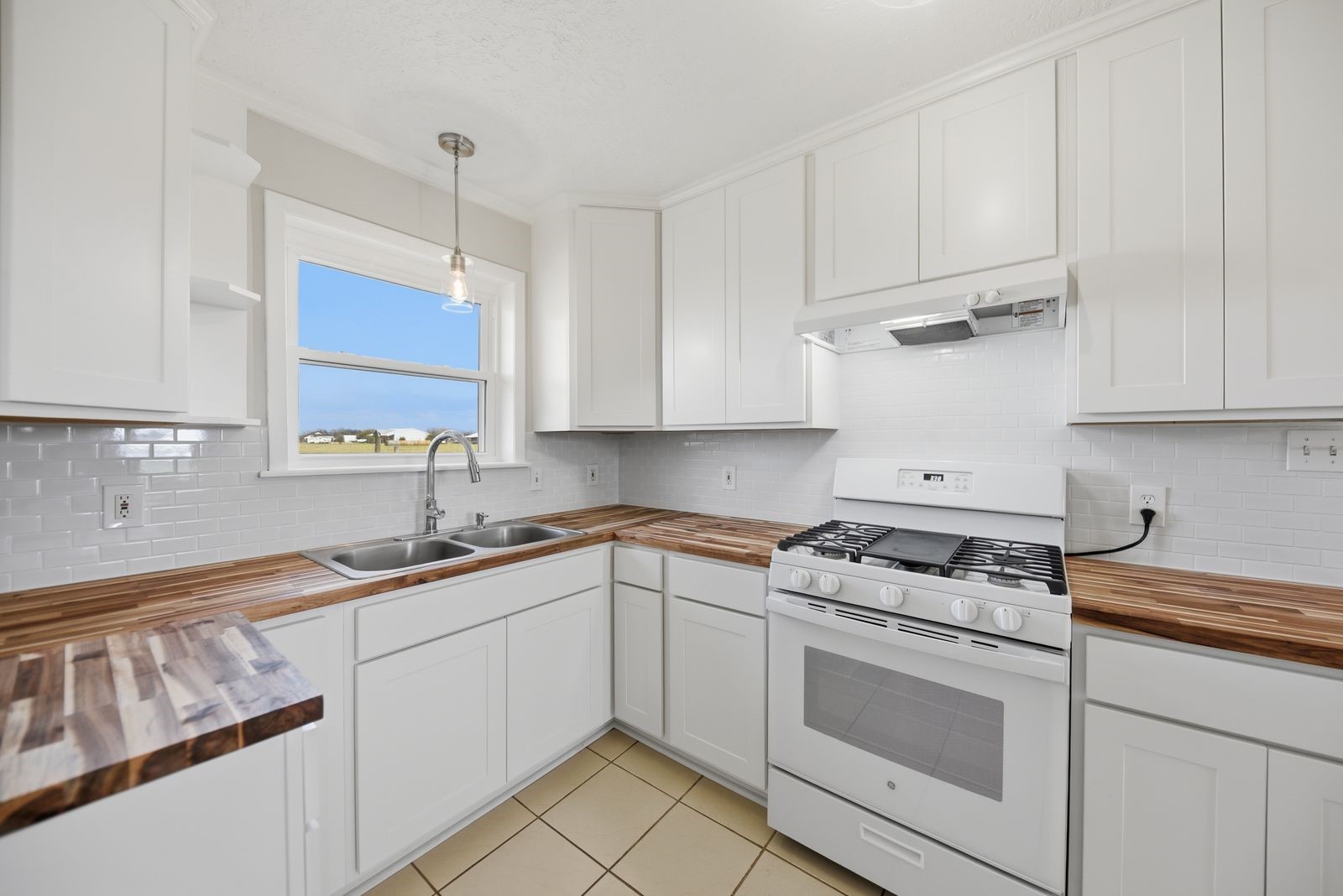 3249 Newsom Road Bellville, TX 77418 - Photo 5 of 20 a kitchen with cabinets appliances a sink and a counter top
