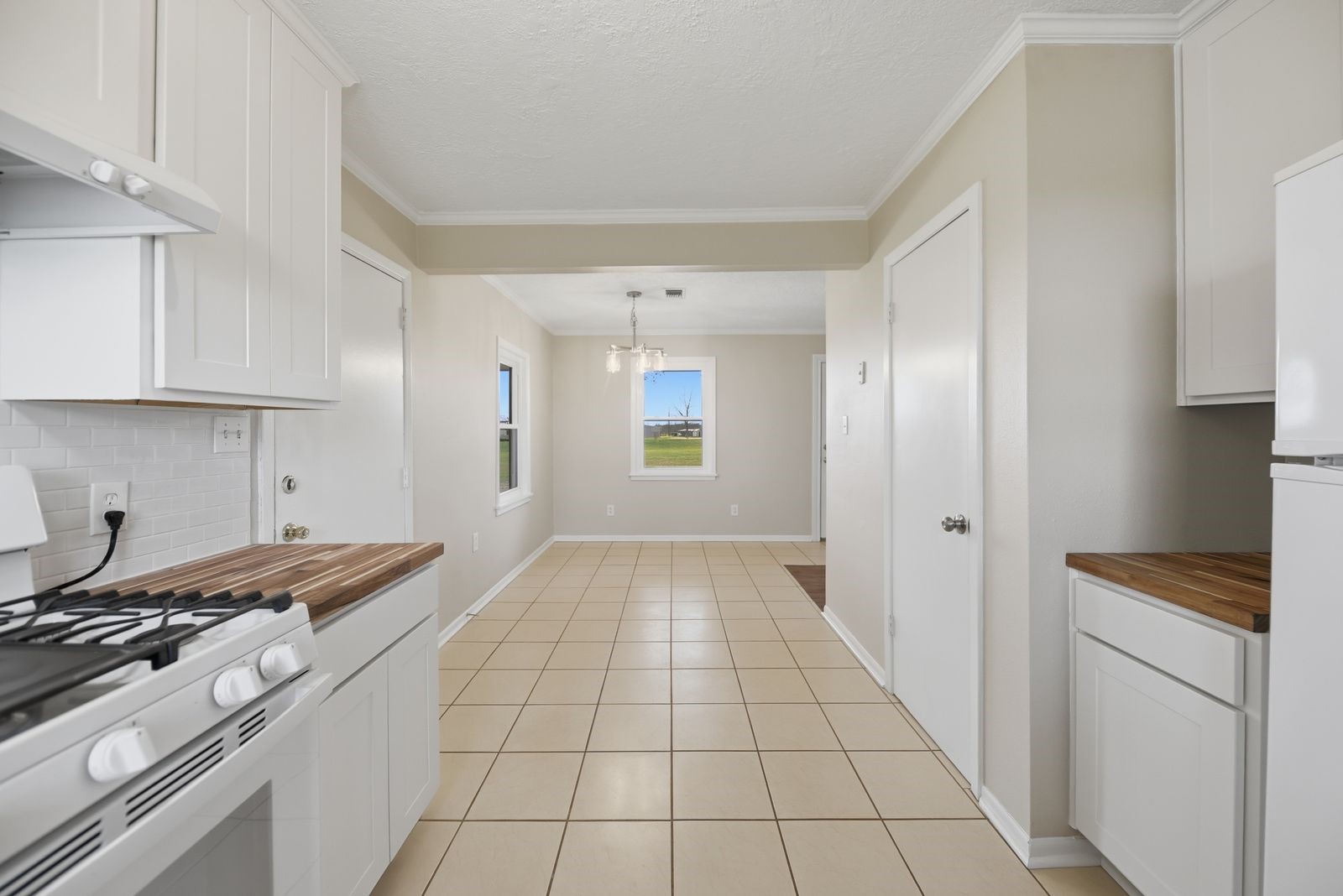 3249 Newsom Road Bellville, TX 77418 - Photo 7 of 20 a kitchen with a stove cabinets and a refrigerator