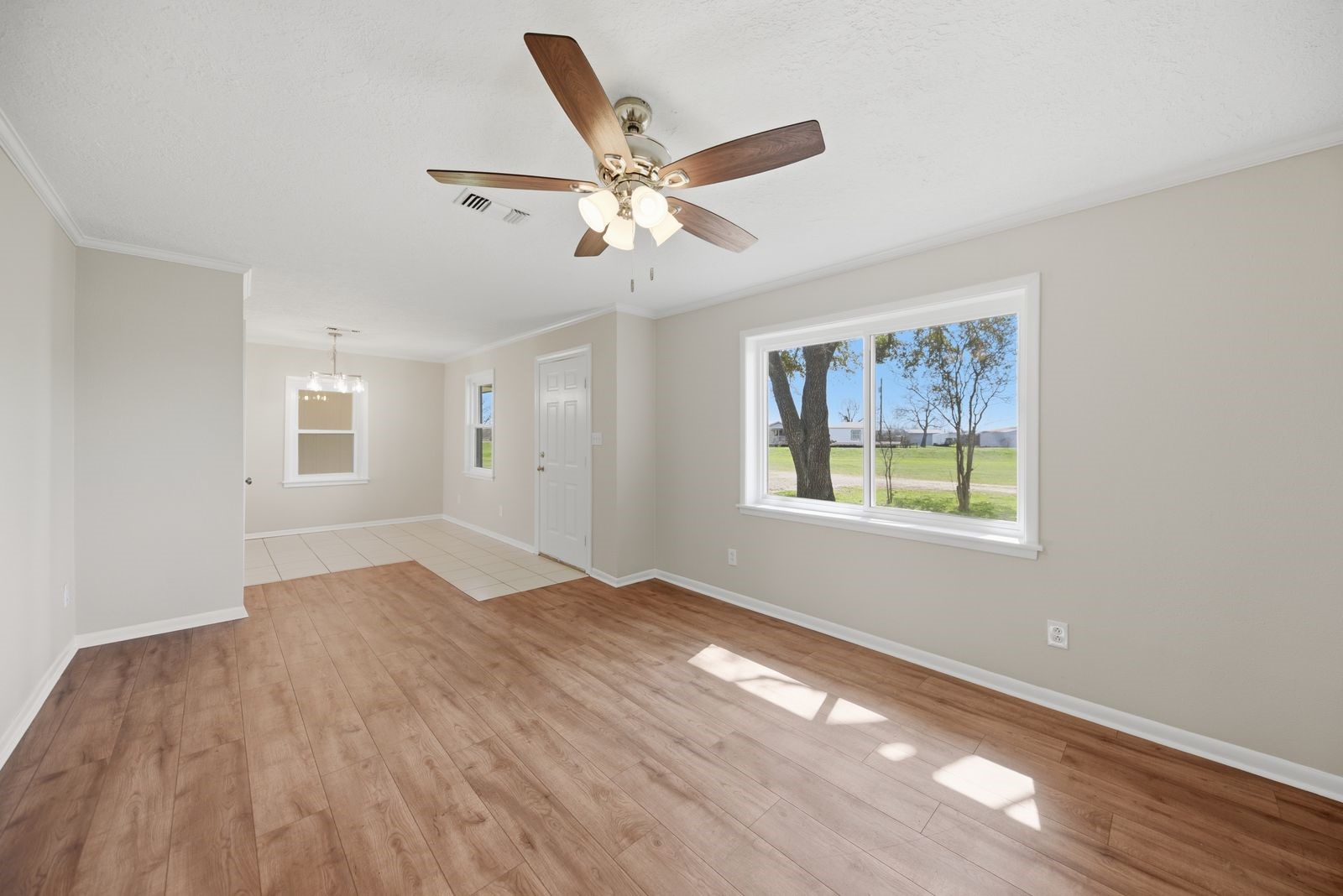 3249 Newsom Road Bellville, TX 77418 - Photo 8 of 20 a view of an empty room with wooden floor and a window