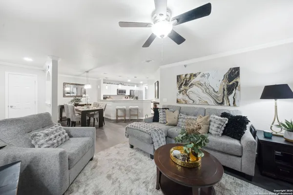 a living room with furniture and a chandelier
