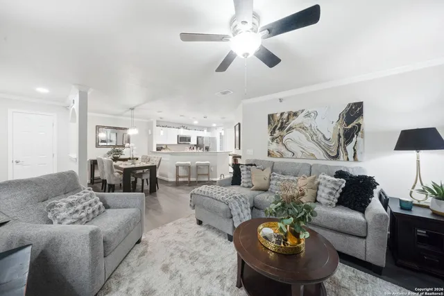 a living room with furniture and a chandelier