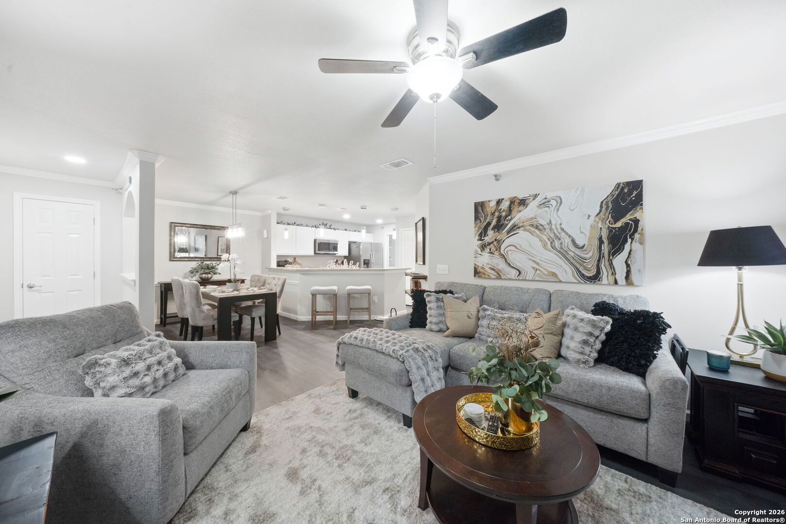 a living room with furniture and a chandelier