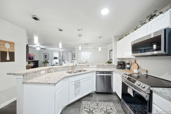 a kitchen with a sink stove and microwave