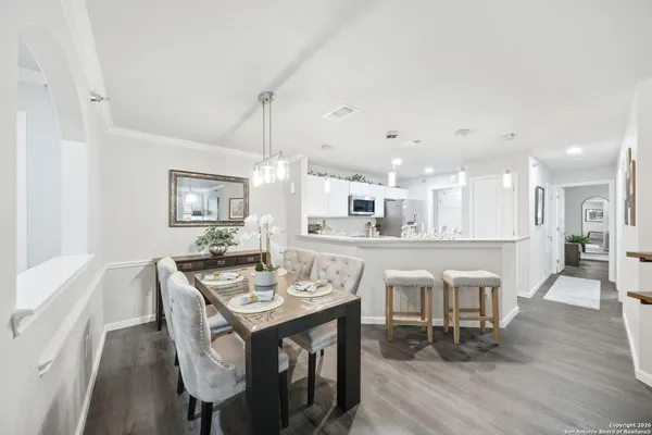 a view of a dining room with furniture wooden floor and chandelier