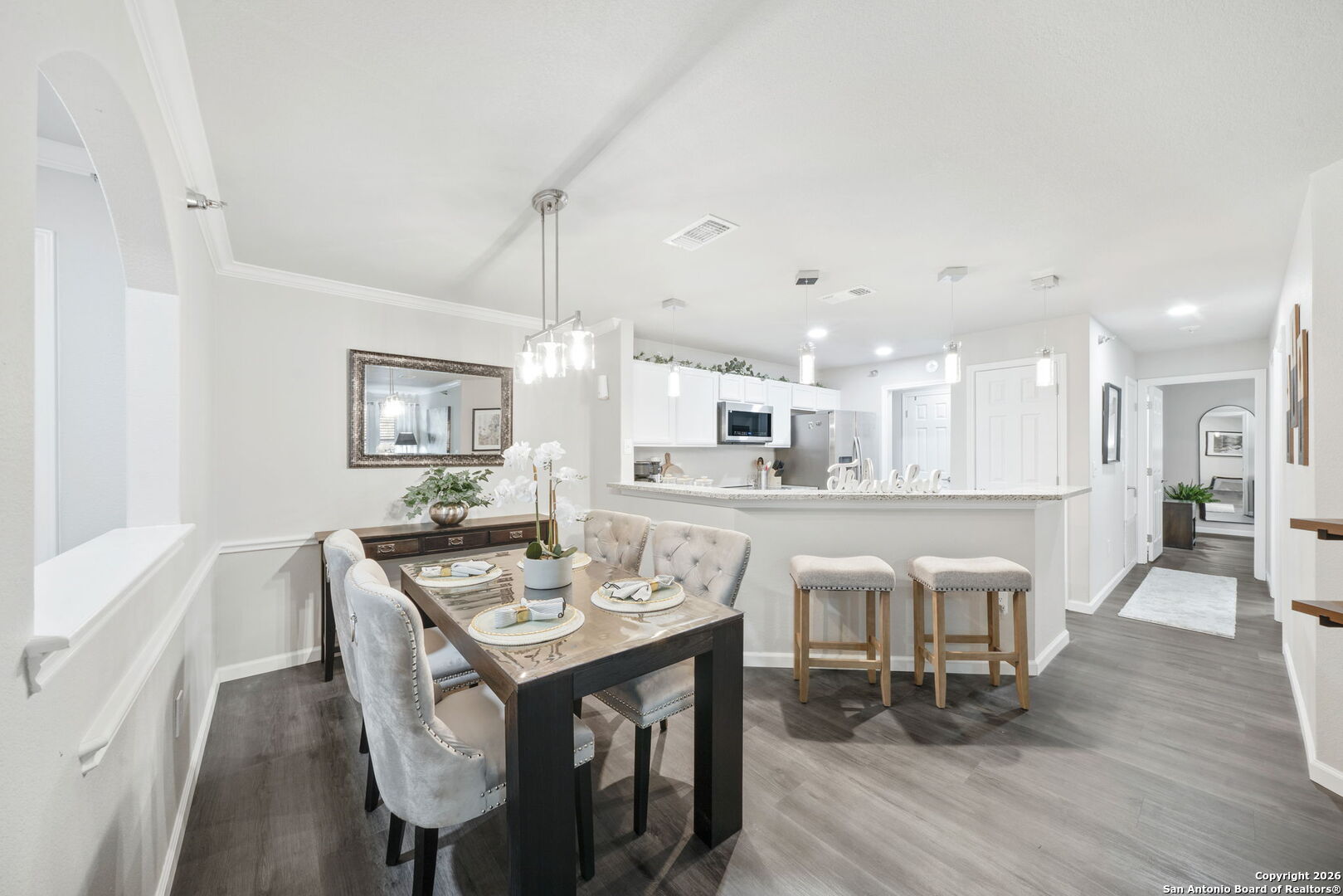 7323 Snowden Road, Unit 2201 San Antonio, TX 78229 - Photo 16 of 27 a view of a dining room with furniture wooden floor and chandelier