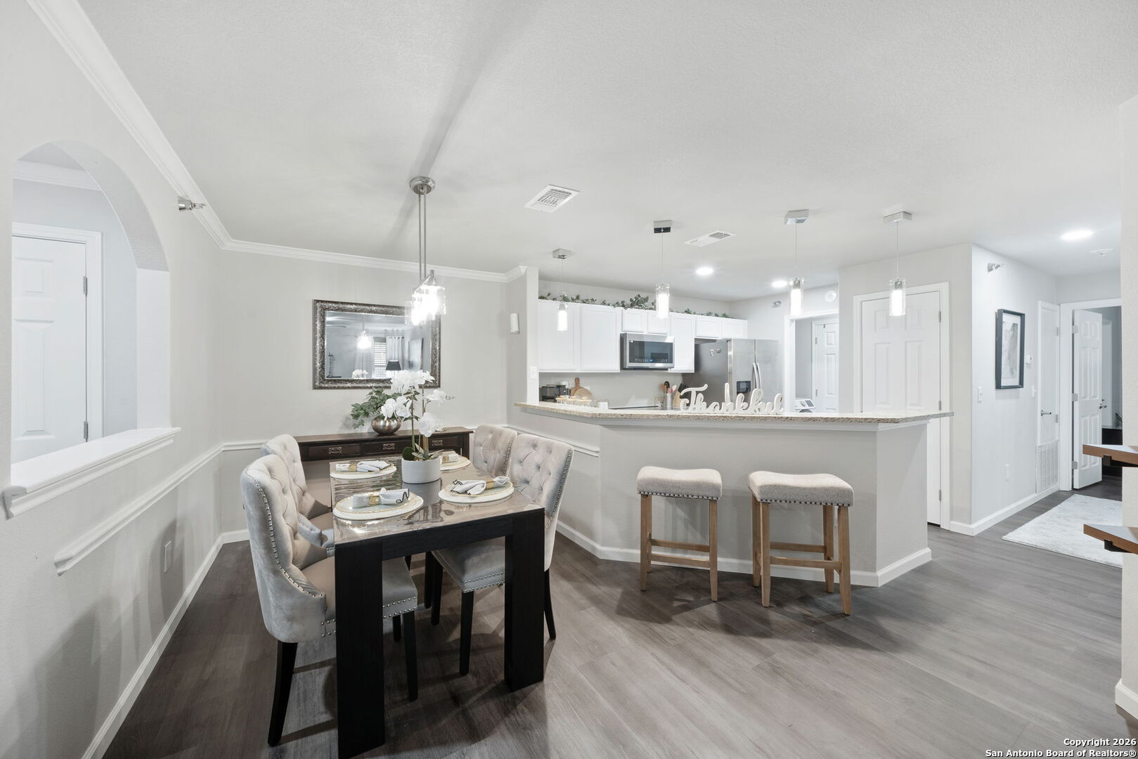 7323 Snowden Road, Unit 2201 San Antonio, TX 78229 - Photo 19 of 27 a dining area with a table chairs and a kitchen view