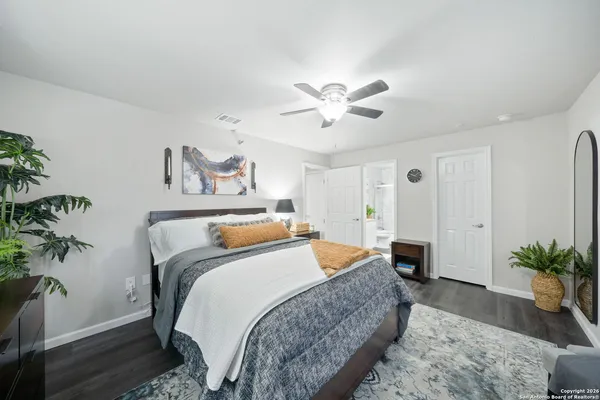 a bedroom with bed and a potted plant