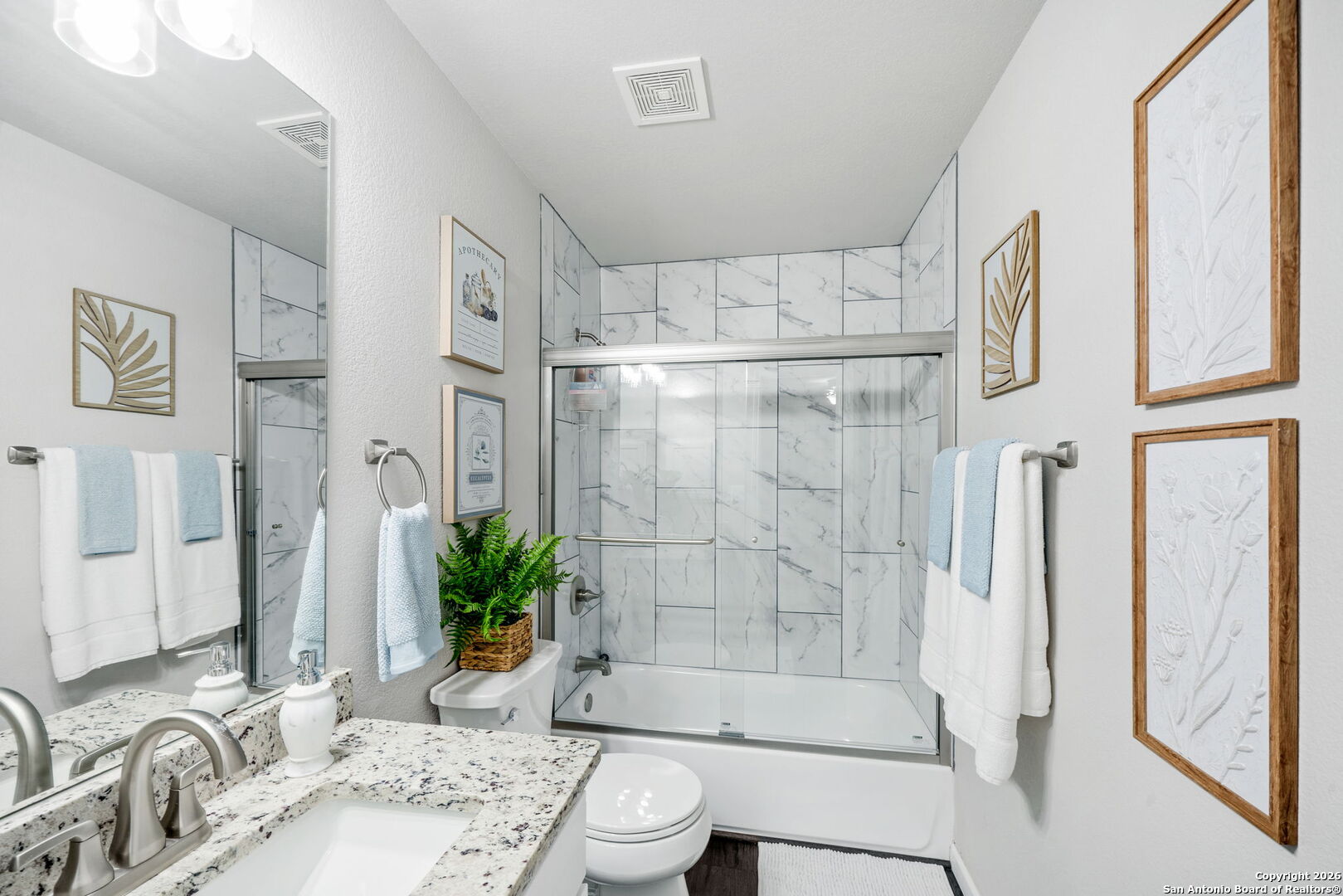 7323 Snowden Road, Unit 2201 San Antonio, TX 78229 - Photo 23 of 27 a bathroom with a granite countertop sink a toilet and shower