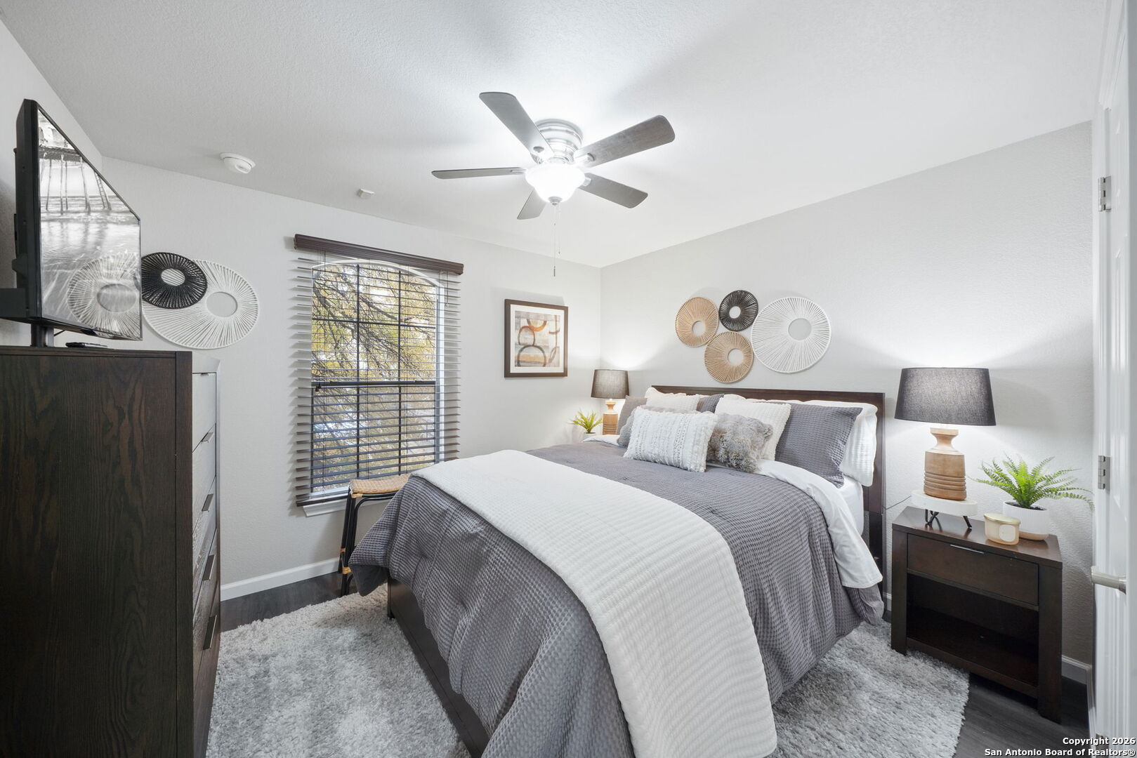 7323 Snowden Road, Unit 2201 San Antonio, TX 78229 - Photo 27 of 27 a bedroom with a bed and a chandelier