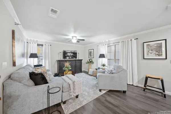a living room with furniture and a chandelier