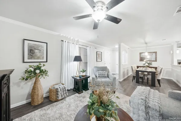 a living room with furniture potted plant and a chandelier