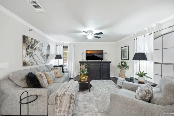 a living room with furniture and a flat screen tv