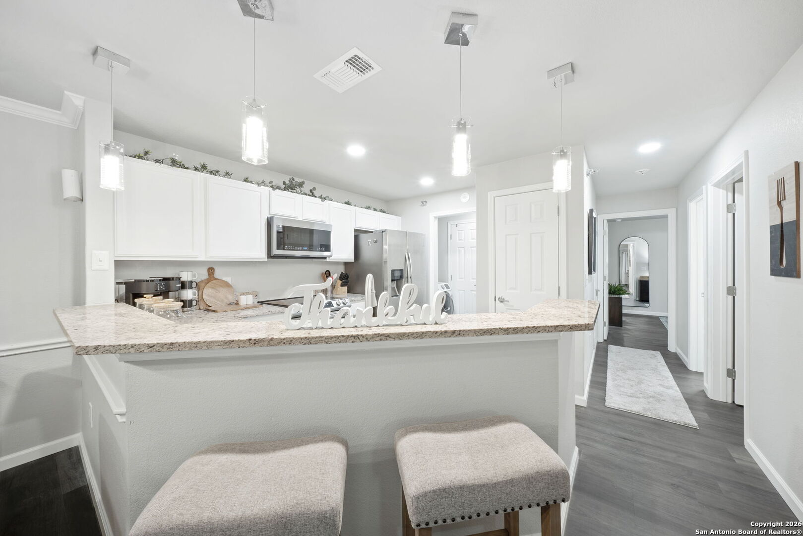 7323 Snowden Road, Unit 2201 San Antonio, TX 78229 - Photo 10 of 27 a kitchen with stainless steel appliances granite countertop a sink a stove a refrigerator with wooden floor