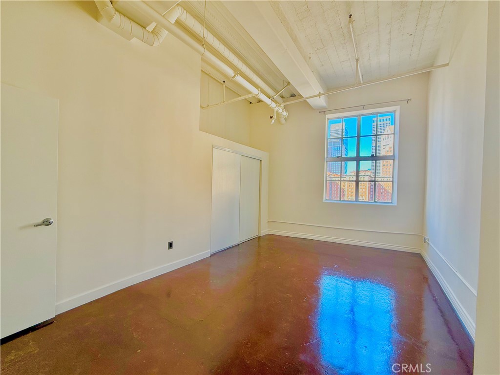 312 West 5th Street, Unit 903 Los Angeles, CA 90013 - Photo 6 of 12 a view of empty room with window and wooden floor