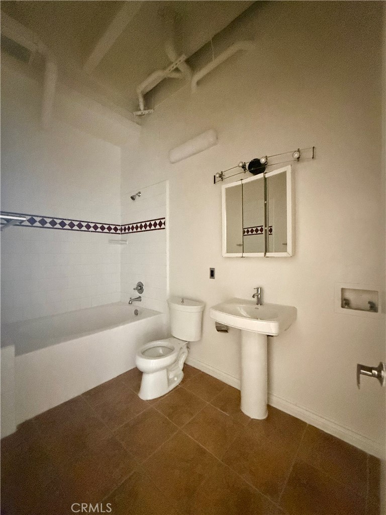 312 West 5th Street, Unit 903 Los Angeles, CA 90013 - Photo 8 of 12 a bathroom with a sink a toilet and bathtub